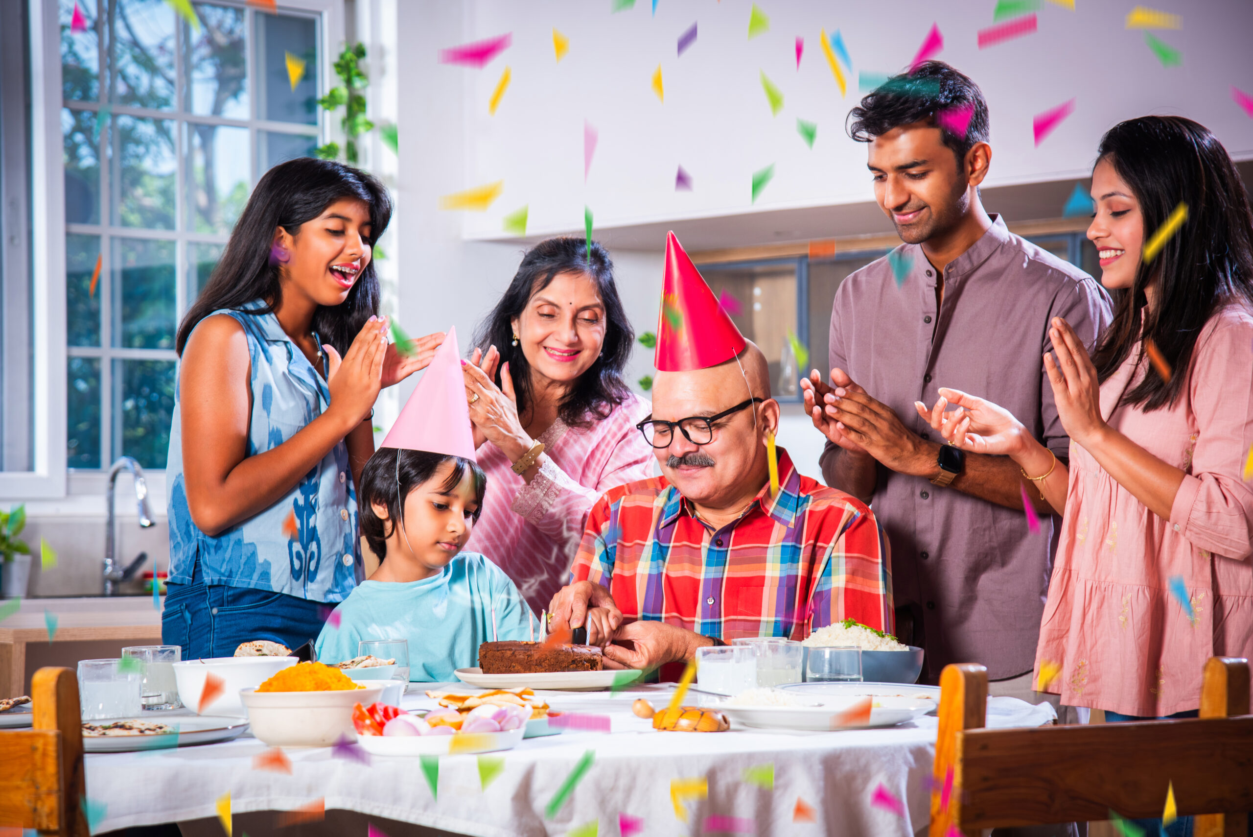 Indian asian family celebrating a birthday party at home