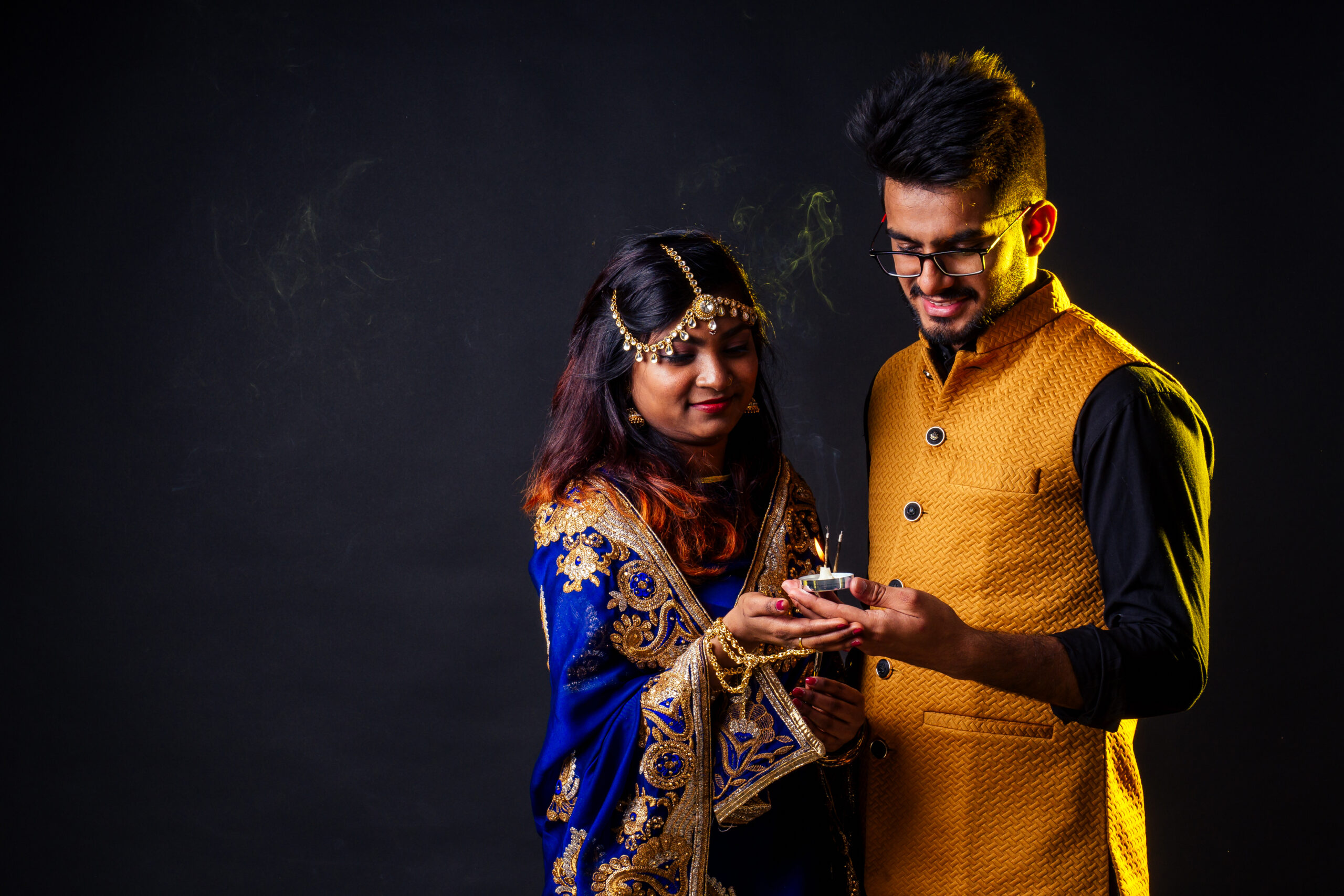 indian female and hindu man celebration divali studio background .