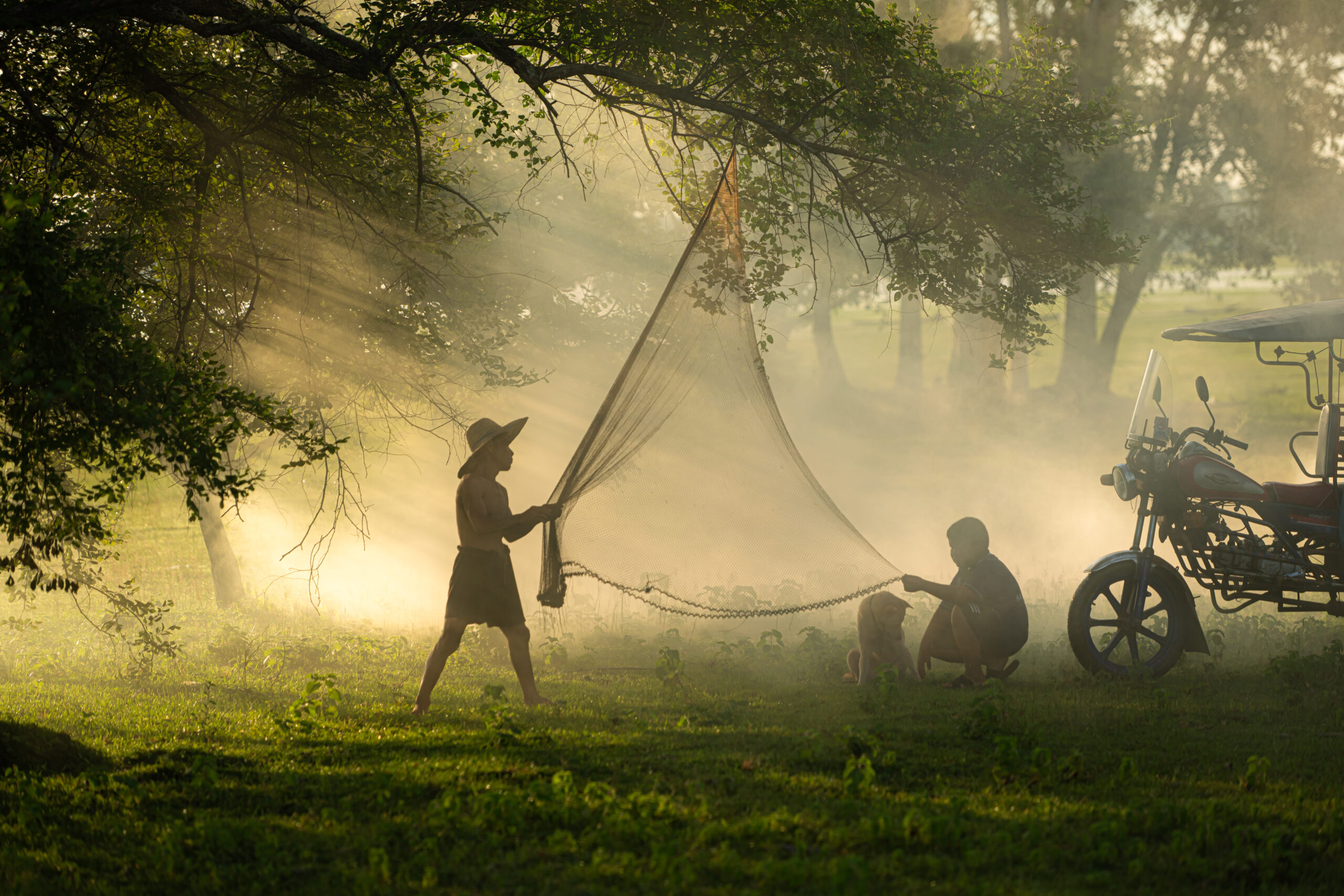 Local fisherman prepare a fishnet under the tree to capture fish in the lake